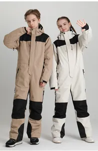 Detail of waterproof children's ski suit featuring adjustable hoods and zipper pockets