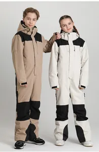 Close-up of waterproof fabric and adjustable velcro cuffs on kids one-piece ski suit