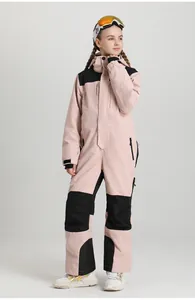 Detail of kids pink and black one-piece ski suit with waterproof zippers and velcro cuffs