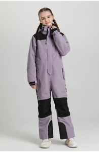 Detail of kids one-piece ski suit in lilac and black featuring waterproof zip pockets