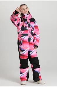 Detail of waterproof kids ski suit featuring pink mountain prints and adjustable cuffs