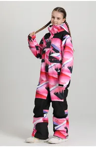 Detail of kids one-piece ski suit with colorful mountain print and velcro cuffs