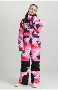 Detailed view of children's pink one-piece ski suit with mountain print and reinforced hems
