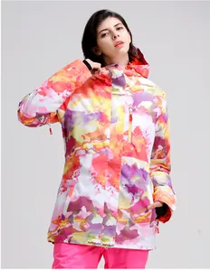 Detail of colorful marble pattern women's ski jacket with hood and chest zipper pocket