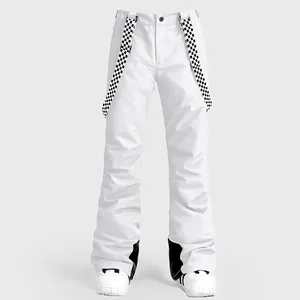 Waterproof white ski bib pants with checkered suspenders and reinforced inner cuffs