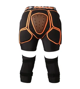 Padded protective gear set for skiing with black impact shorts and orange detailed knee pads