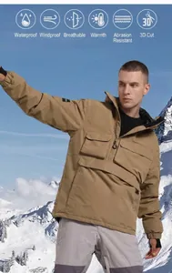 Close-up of khaki waterproof ski anorak showing functional pockets and 3D cutting detail