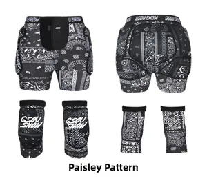 Detail view of GSOU SNOW paisley print padded ski shorts and matching knee pads