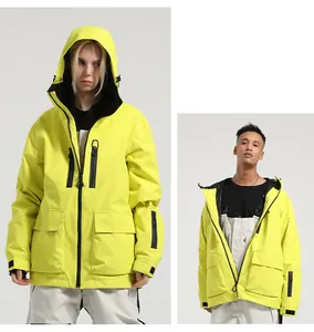 Detail view of neon yellow waterproof ski jacket with hood and black zipper pockets