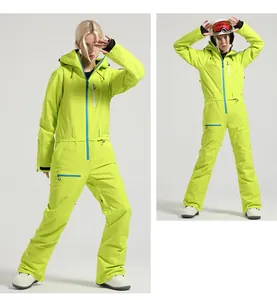 Detail of neon green one-piece ski suit with blue contrast zippers and functional pockets