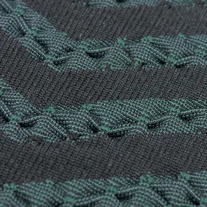 Close-up of thermal ski underwear with green and black wave textured knit fabric