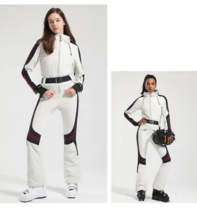 Detail view of female slim-fit one-piece ski suit with color-block stripes and waist belt