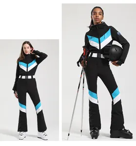 Dettaglio della tuta da sci slim-fit con motivi a V blu e bianchi su tessuto nero