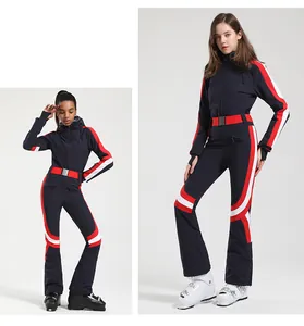 Detail of slim-fit navy blue ski suit with red accents and a buckle waist belt