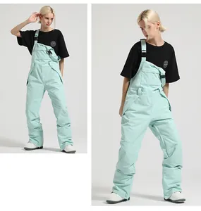 Front and side view of mint green women's ski bib overalls with adjustable shoulder straps