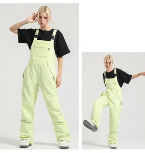 Detail of lime green ski bib pants showing adjustable straps and waterproof utility pockets