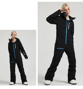 Detail of waterproof one-piece ski suit with blue zippers and reinforced seams