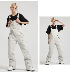 Detail view of beige waterproof ski bib overalls with adjustable straps and chest pocket