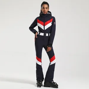 Tuta da sci intera da donna blu navy con strisce chevron rosse e bianche e cintura