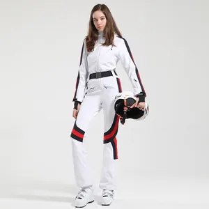 Slim fit white one-piece women's ski suit with red and blue stripes and black belt