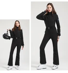 Close-up of slim-fit black one-piece ski suit featuring a belted waist and logo detail