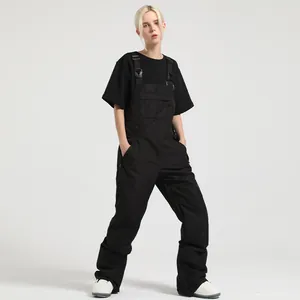 Women's black waterproof ski bib pants with adjustable straps and multiple pockets
