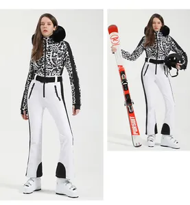 Detail of leopard print ski suit with faux fur hood and white waterproof pants