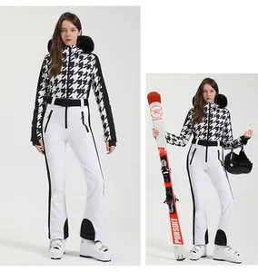 Detail view of women's houndstooth ski suit with fur hood and professional waist belt