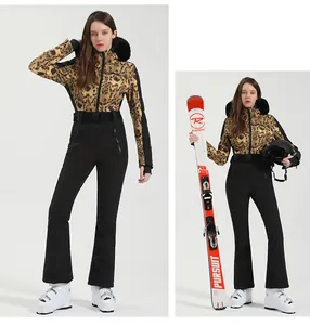 Detail of leopard print ski jacket with black fur hood and matching slim belted ski pants