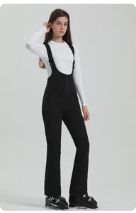 Close-up of black ski bib pants with adjustable elastic straps and high waist for women