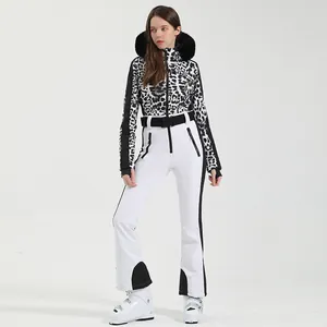 Women's one-piece ski suit featuring leopard print top and white pants with fur hood