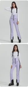 Detail of lavender high-waist ski bib with adjustable straps and waterproof zipper pockets