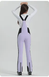 Detail of light purple and black waterproof women's ski bib pants showing side panels