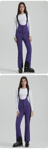 Detail view of purple ski bib with waterproof fabric and protective black knee patches