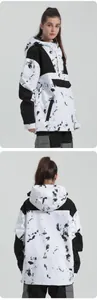 Macro view of waterproof ski jacket featuring black and white splatter print and hood detail