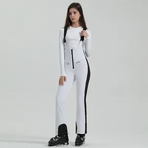 Women's white waterproof ski bib pants with black straps and slim fit thermal design