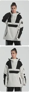 Detail of hooded ski jacket featuring black and white contrast panels and cargo pockets