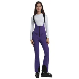 Women's purple insulated bib ski pants with adjustable straps and waterproof fabric
