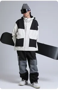 Detail of loose-fit color-block waterproof ski suit with professional hooded jacket and pants
