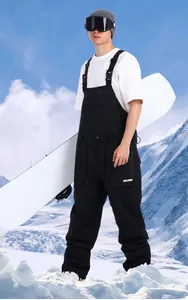 Close-up of black men's ski bib featuring cargo pockets and white GSDU SNOW logo on the thigh