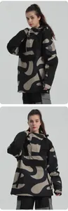 Detail of color-block hooded ski jacket with camouflage pattern and front utility pocket