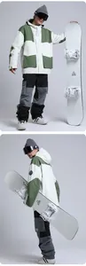 Front and back detail of a green and white color-block professional men's ski jacket and pants