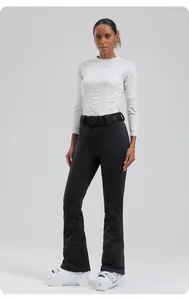 Close-up of slim-fit waterproof ski pants with branded belt and protective ankle cuffs