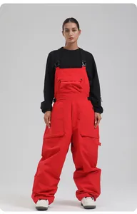 Detail einer roten wasserdichten Skilatzhose mit schwarzen Trägern und Cargo-Taschen