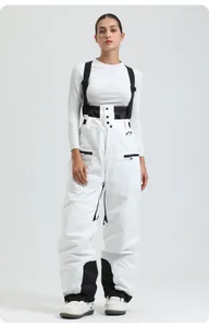 Detail of white high-waisted ski bib with black adjustable straps and reinforced knee panels