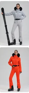 Detail of professional women's quilted ski jacket with fur hood and slim ski pants