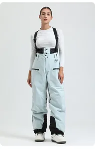 Detail view of light blue padded bib ski pants with black elastic waist and reinforced cuffs