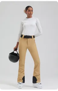 Slim fit khaki ski pants for women with black reinforced ankle patches and branded belt
