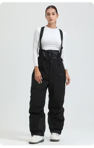Detail of high-waisted black ski bib pants with adjustable straps and reinforced knees