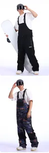 Detail view of waterproof ski bib pants for men with large chest pockets and adjustable straps